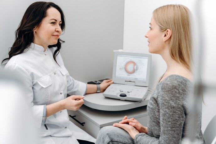 Optometrist-performing-eye-exam-on-patient